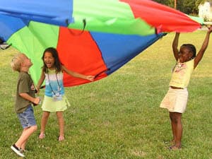 Playing with a parachute on the church lawn