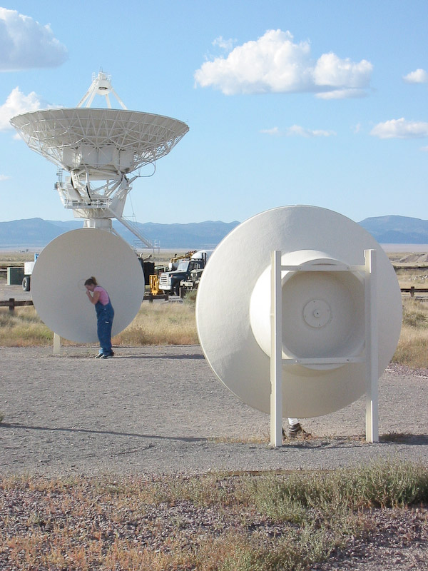 These two dishes allow tourists visiting the Very Large Array to see how faint sound waves can be detected across a distance, much like the VLA works with radio waves.
