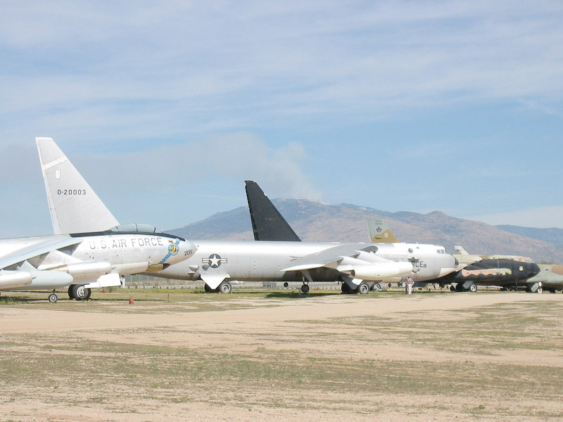 Line of Boeing transports and bombers, Pima Air and Space Museum, Tucson, Arizona. Note the fire on the mountain in the distance.