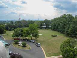 US Naval Observatory. Looking south from the roof of Building 1. The Washington Monument is at the center just above the tree line. The Observatory sits in a perfect circle, deliberately far from any road, to keep vibrations from affecting the instruments. Photo © Lawrence I. Charters